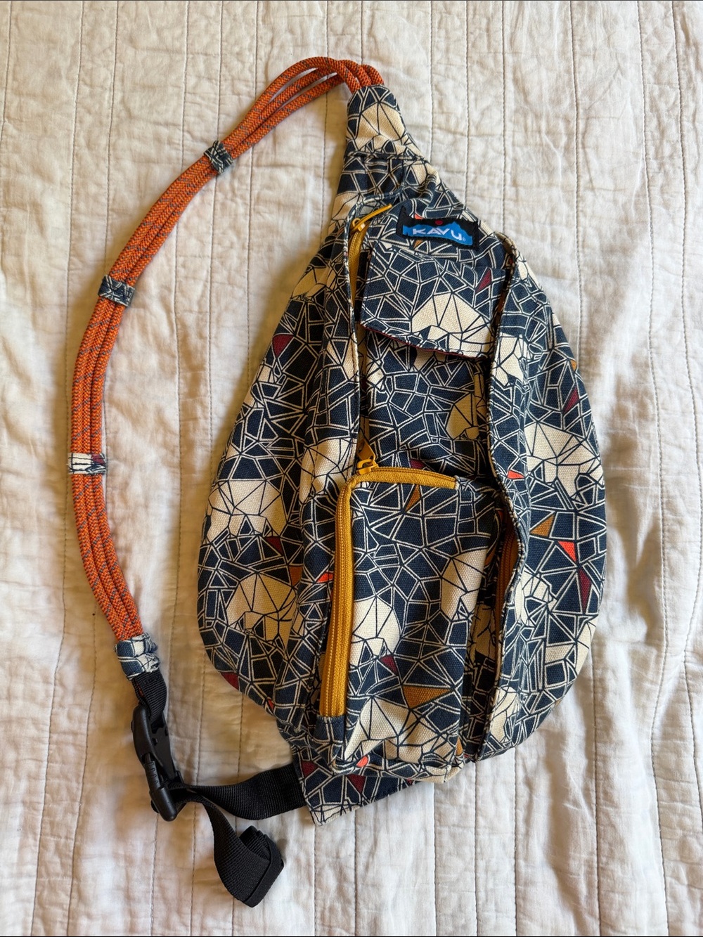Kavu Geometric Mini Rope Sling Bag in Navy, Beige & Orange